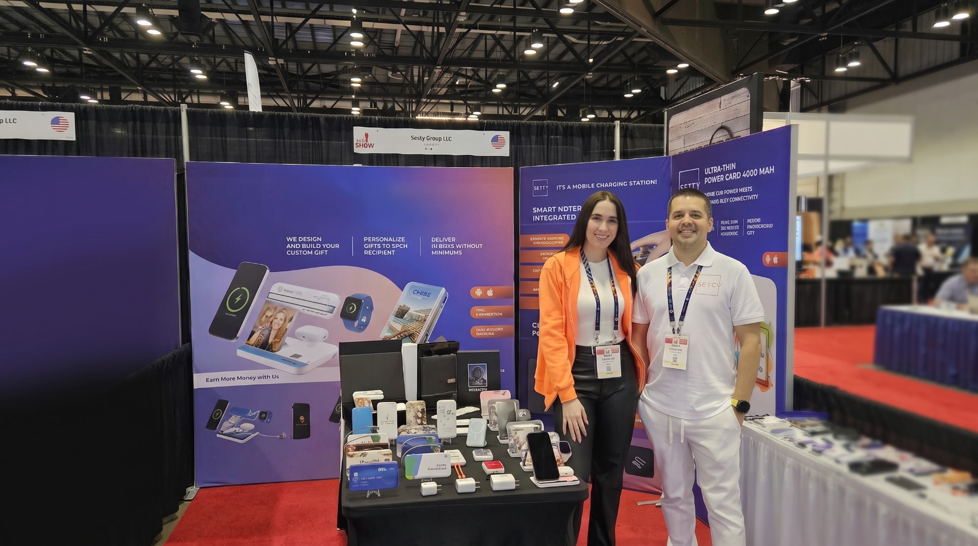 TrendSet Promo Supply booth at an ASI Show with custom branded power banks and wireless charging products on display